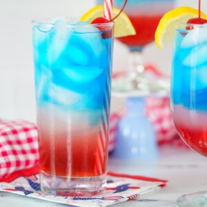 layered red white and blue drink in a tall glass