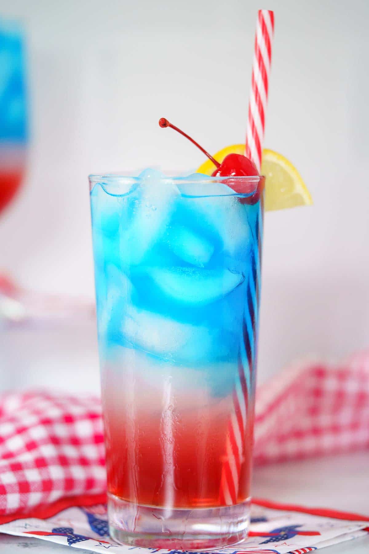 4th of july cocktail with red and white straw