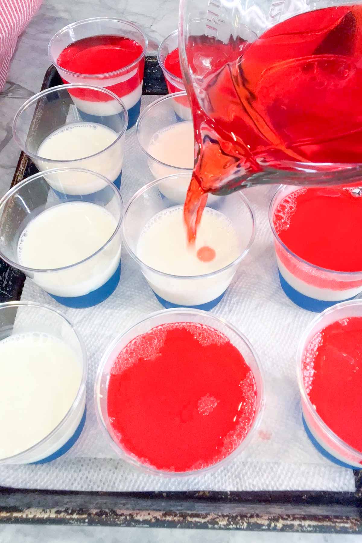 pouring the last jello shot layer 
