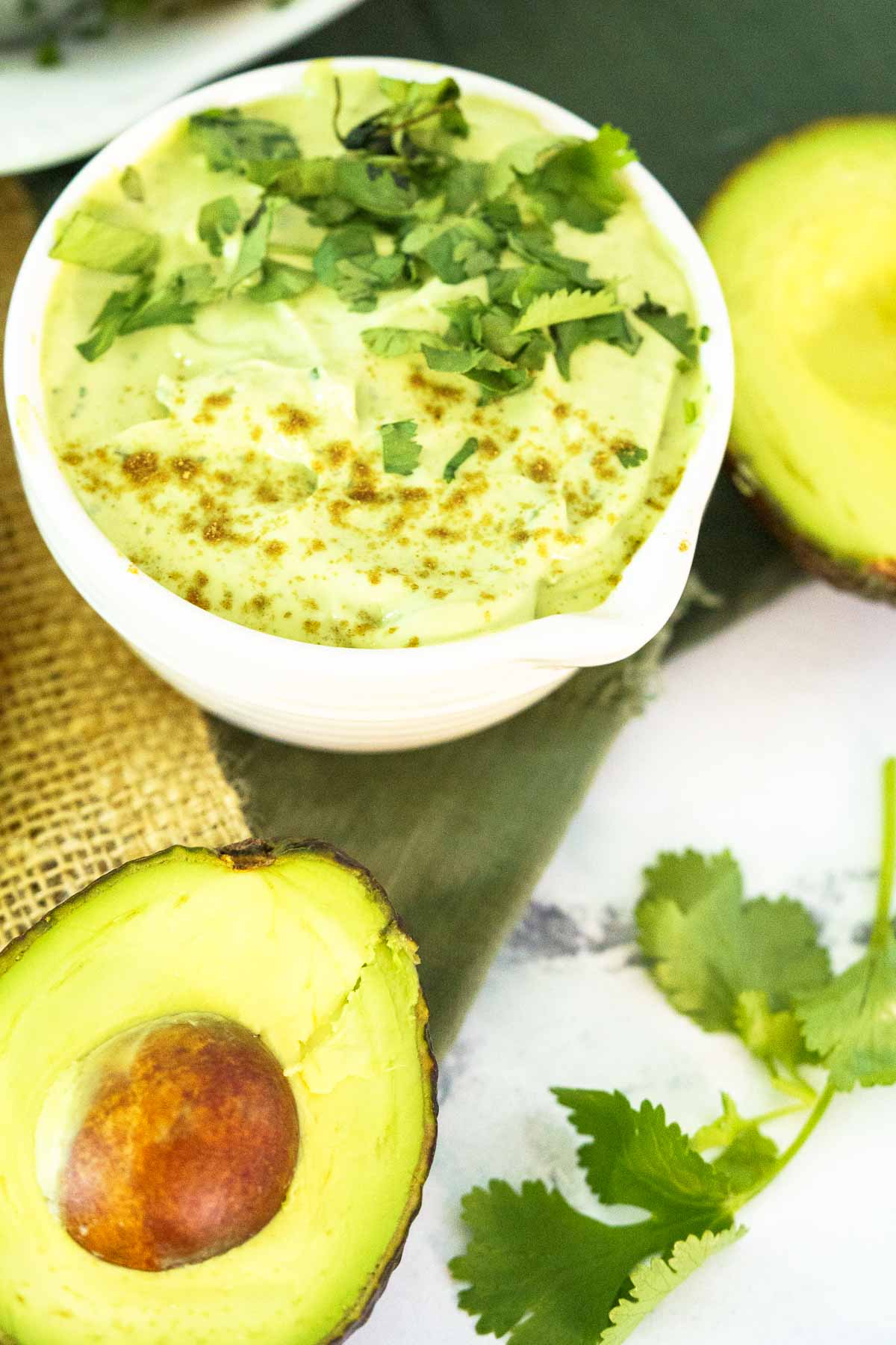 avocado crema in bowl with cilantro garnish