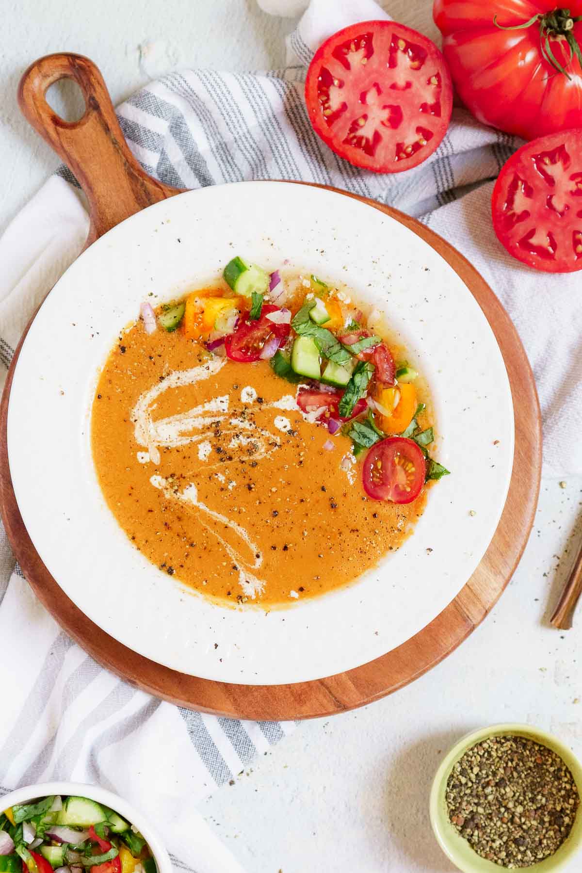 gazpacho in a white bowl with cucumber salad