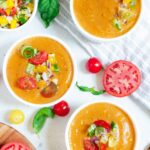 3 bowls of gazpacho soup with a salad