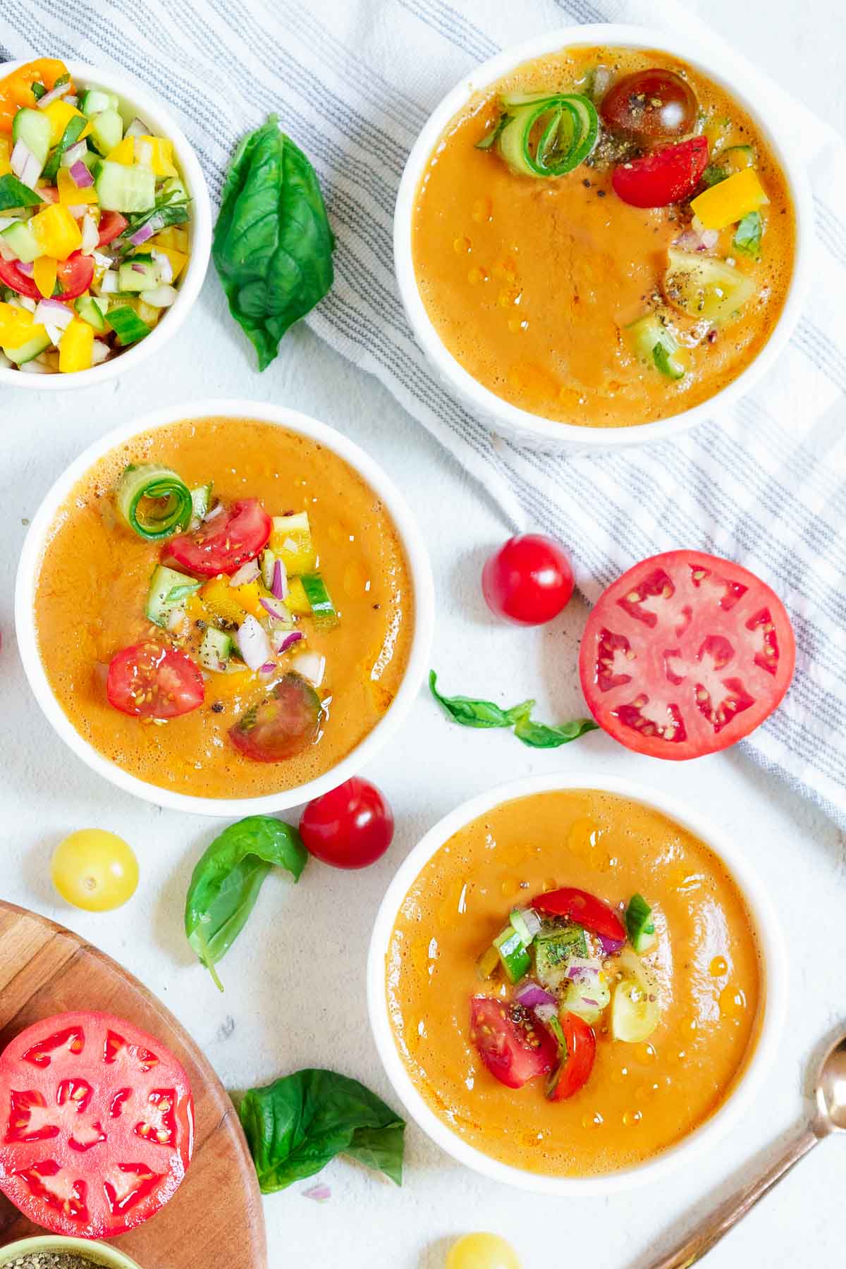 3 bowls of gazpacho soup with a salad