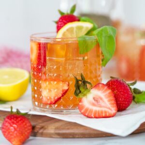 pink cocktail in a glass with fresh strawberries