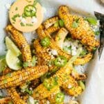 corn ribs with chili dipping sauce on platter