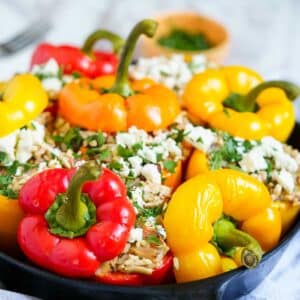 ground chicken stuffed peppers with feta cheese in a pan