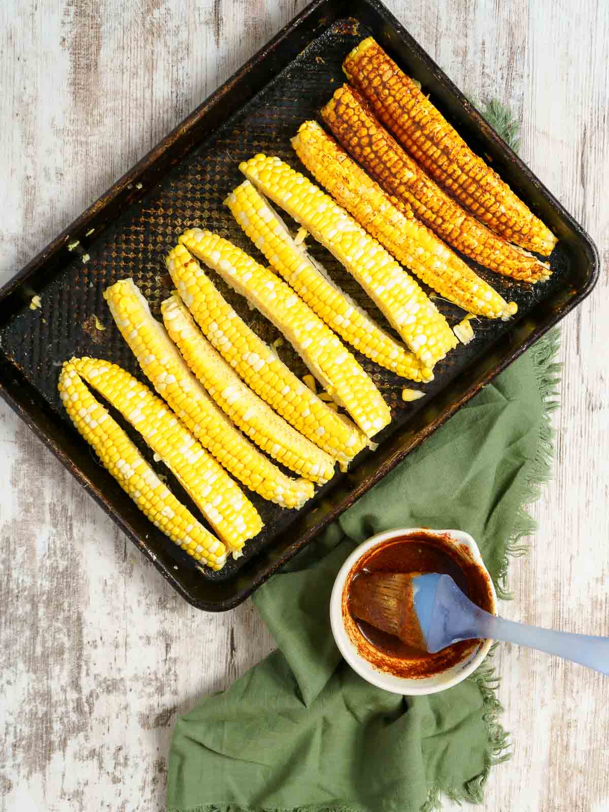 brushing corn ribs with seasoning butter