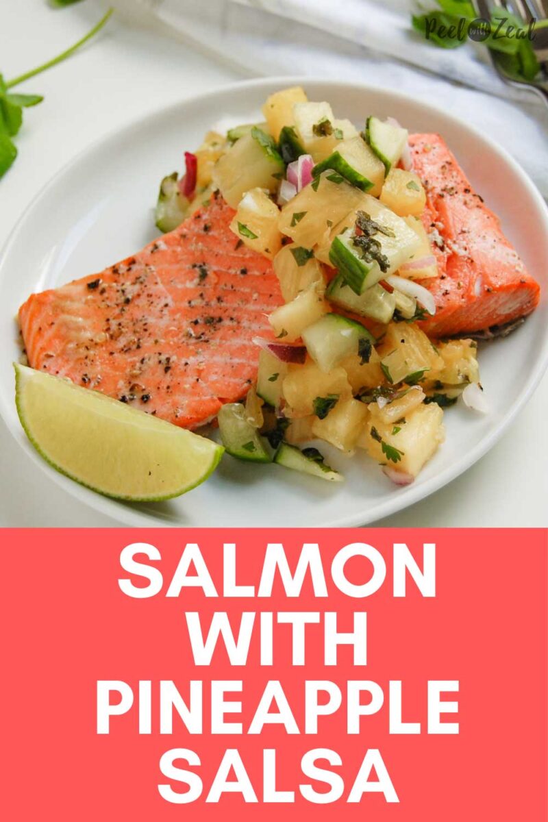 piece of salmon with pineapple salsa on a white plate