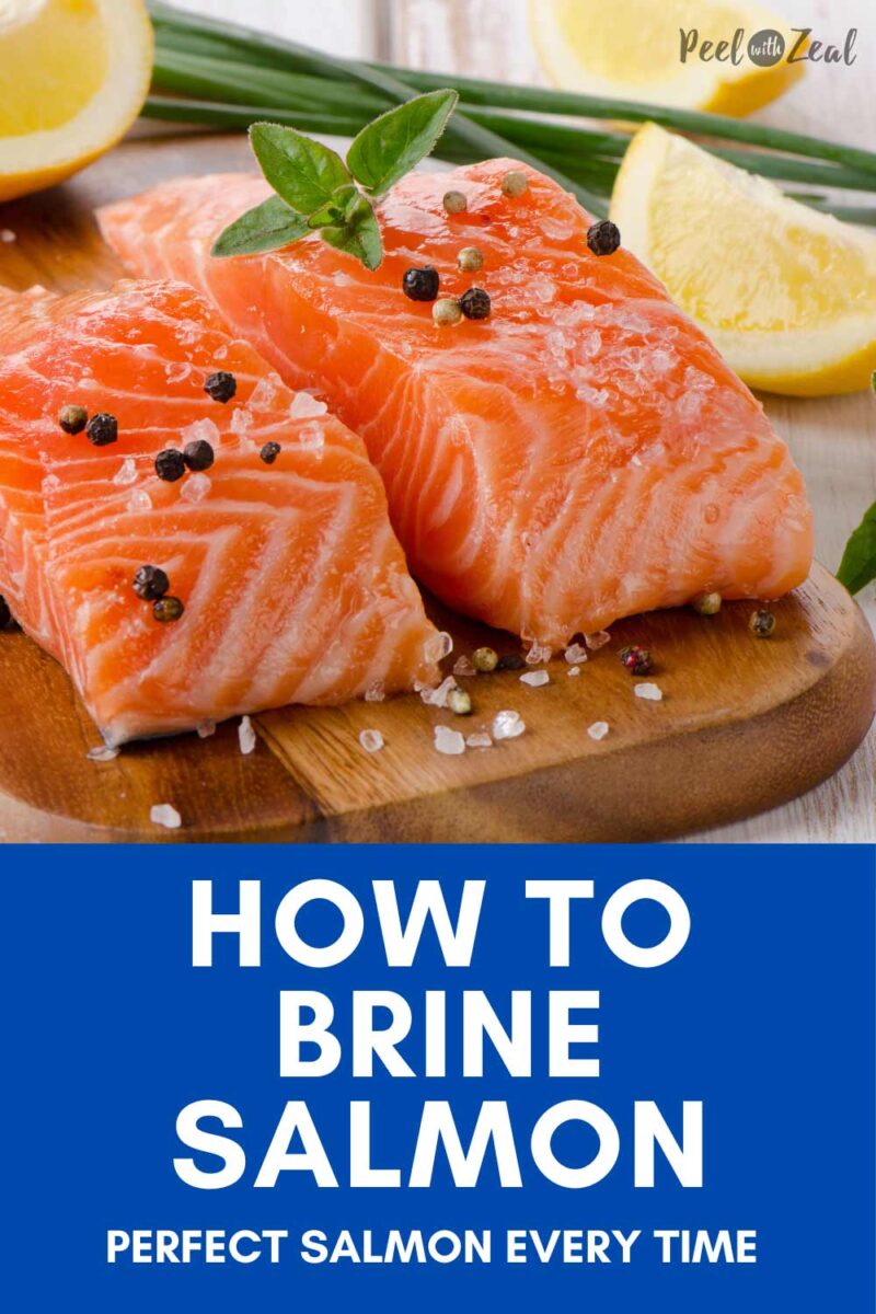 Raw salmon on a cutting board with salt and black pepper.