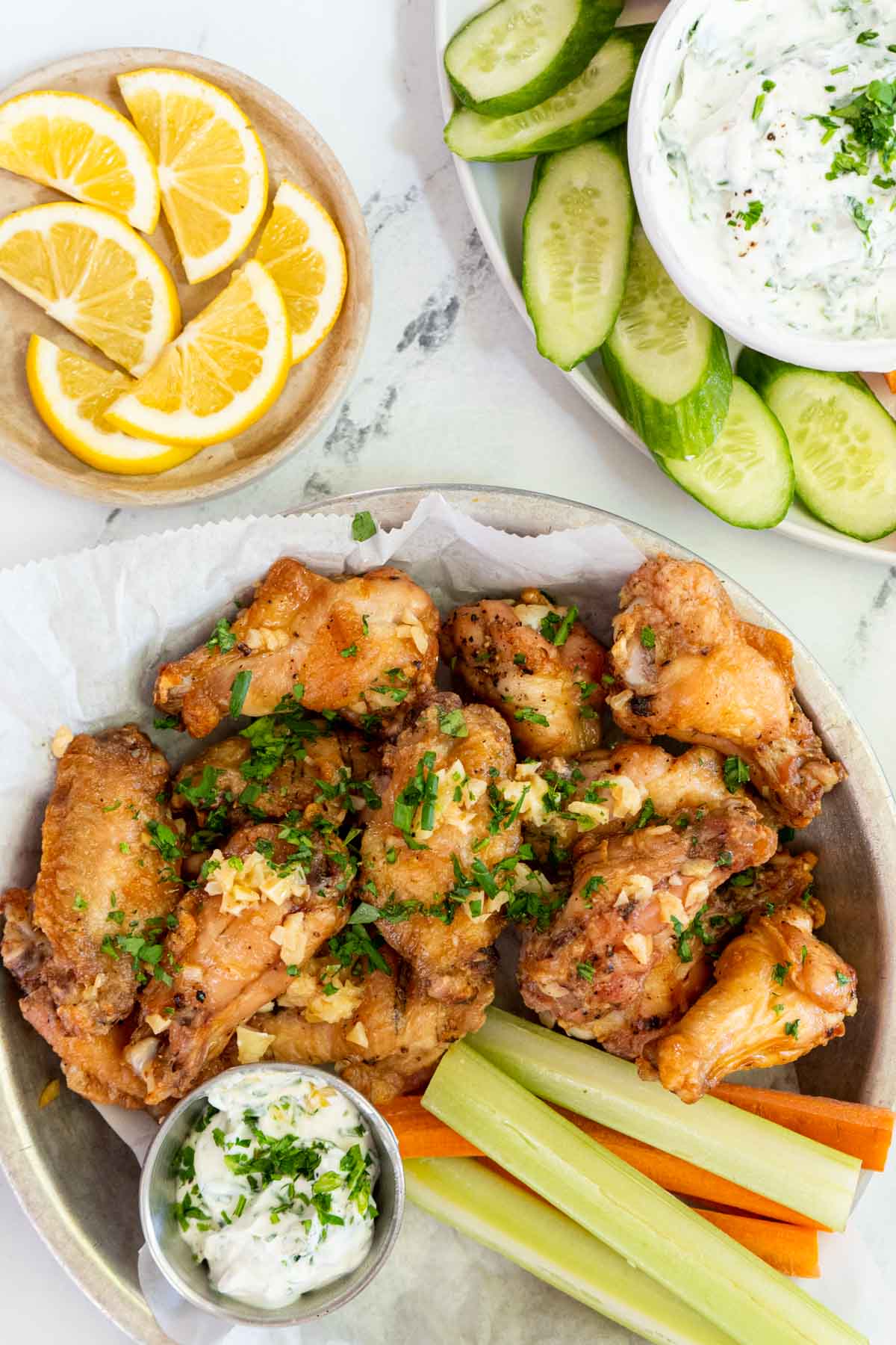 Garlic butter wings on plate with celery and ranch.
