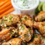 Garlic chicken wings with herbs on a plate.