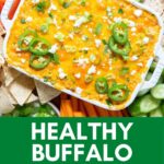 Buffalo chicken dip baked in a white dish. Served with veggies.