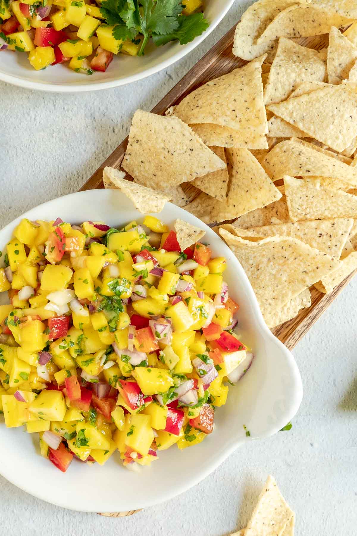 mango salsa and tortilla chips on a platter.