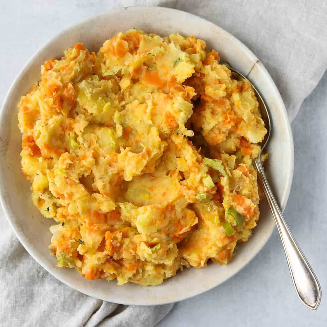 Mashed root vegetables in a bowl.