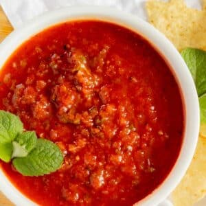 Smooth style salsa in white bowl.