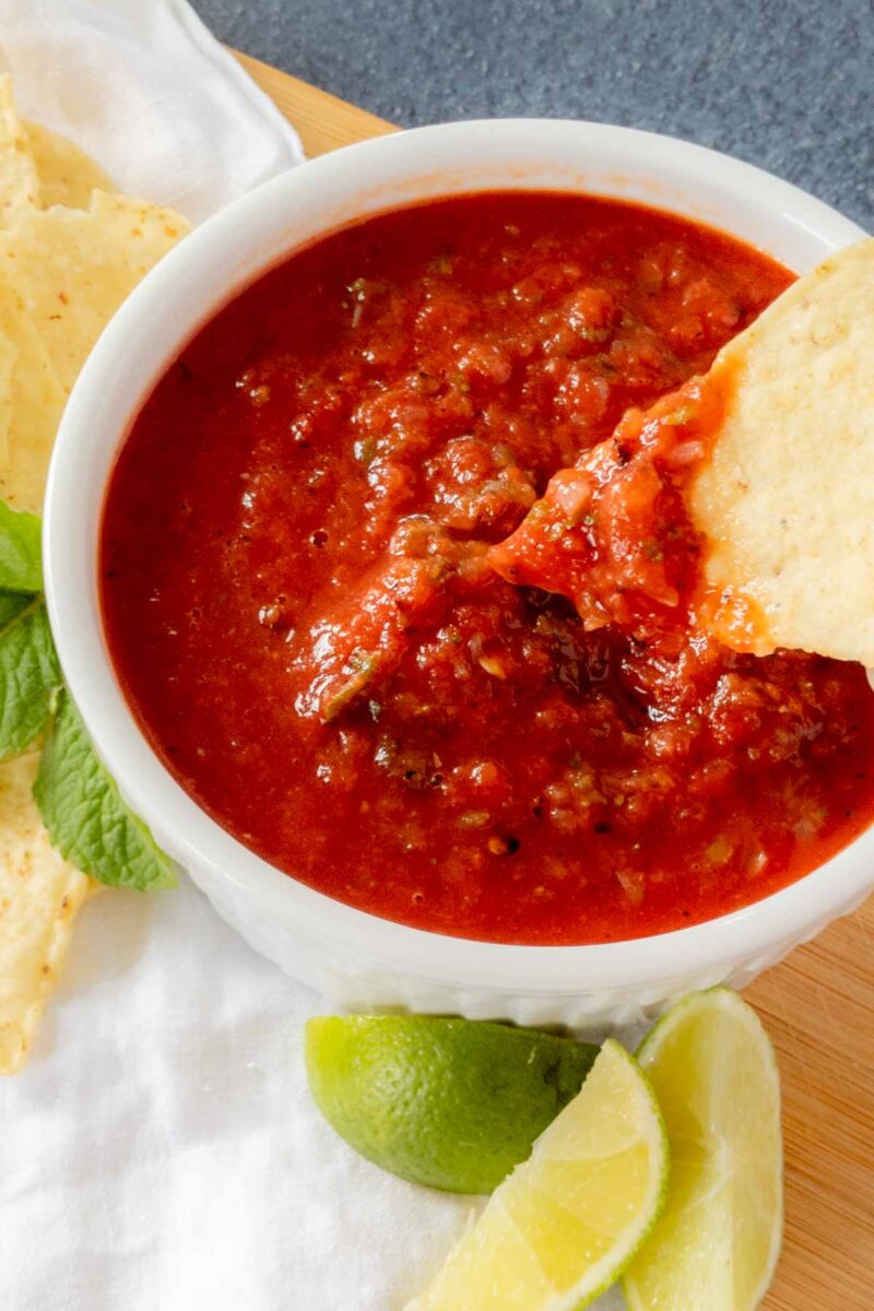 Dipping a tortilla chip into salsa.