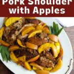 Pork shoulder on a platter with apples and pan sauce.