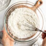 Whisking flour and dry ingredients in a bowl.