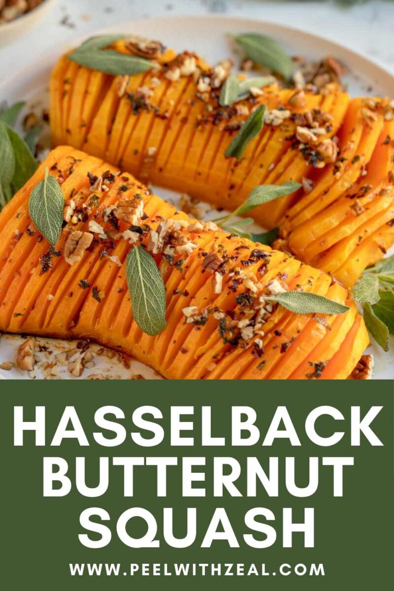 Hasselback style squash on a white plate with sage leaves.