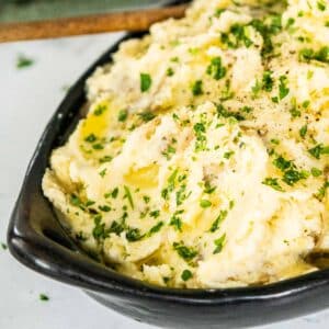 Cheese mashed potatoes in a serving dish.