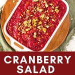 Cranberry salad with walnuts and orange zest in a serving dish.