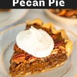 Slice of pecan pie on a white plate with whipped cream.