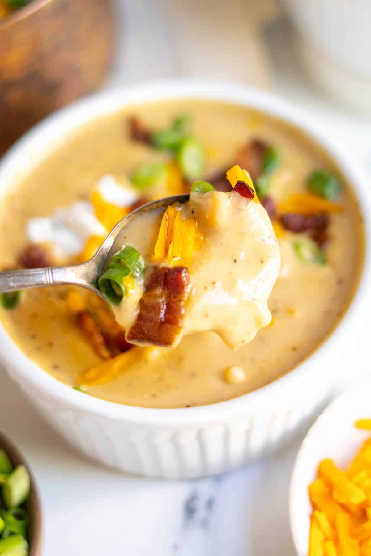 Spooning out creamy potato soup.