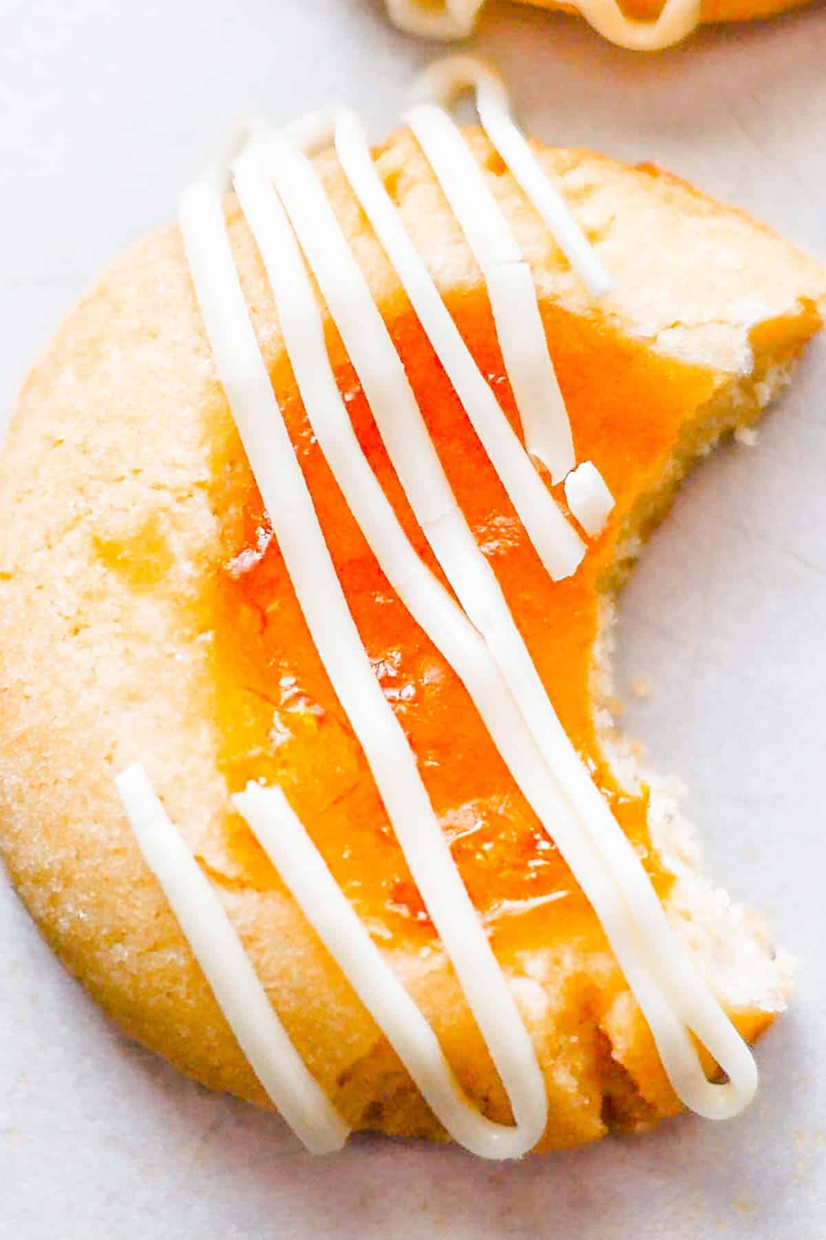 Thumbprint cookie with a bite out of it.