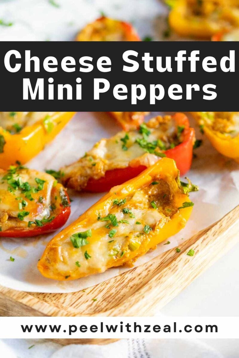 Cream cheese stuffed peppers on a wooden serving board.