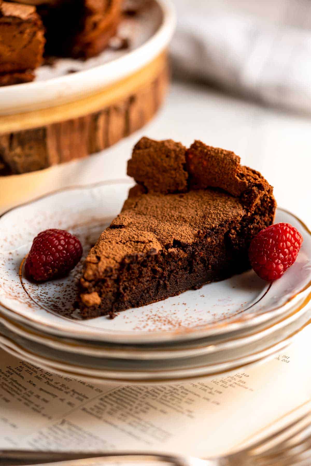 Slice of chocolate cake on a white plate.