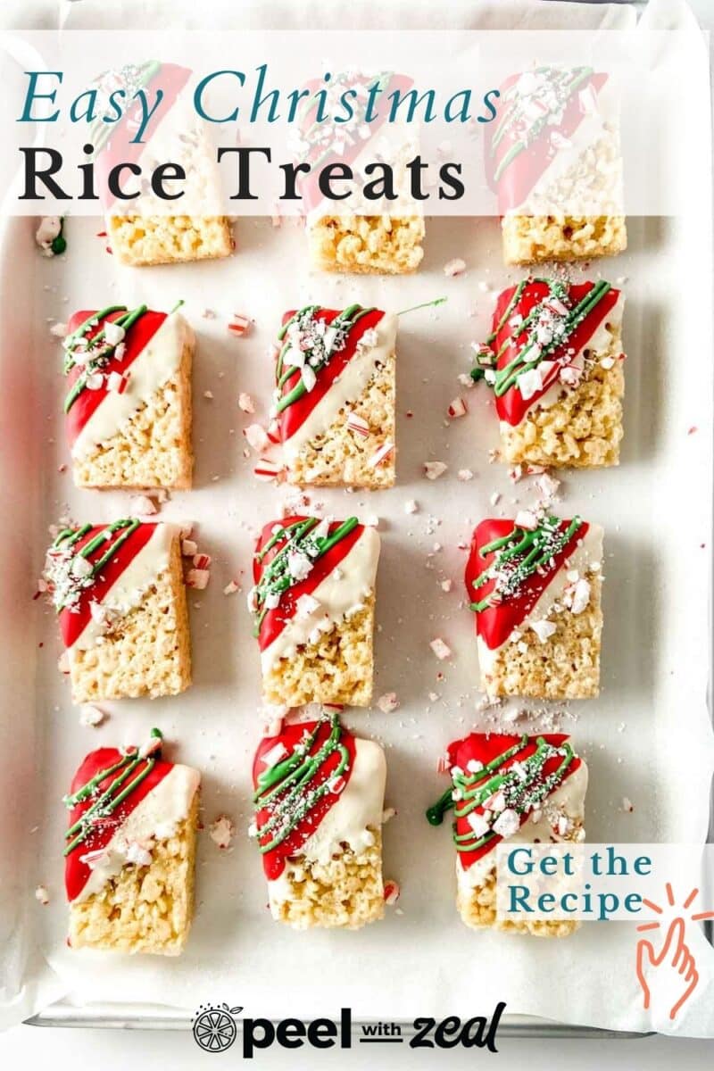 Twelve festive Christmas Rice Krispies treats decorated with red, green, and white icing, sprinkled with crushed candy canes, are neatly arranged in rows on a baking sheet.