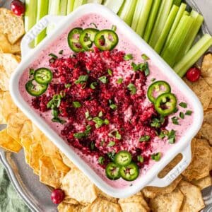 Cream cheese dip topped with cranberries and jalapenos served with crackers.