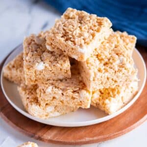 Rice kirspies treats cut into squares and stacked on a plate.