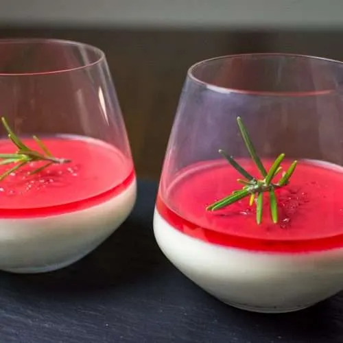 Pomegranate panna cotta in stemless wine glass.