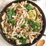 Sausage pasta with broccolini in a pan.