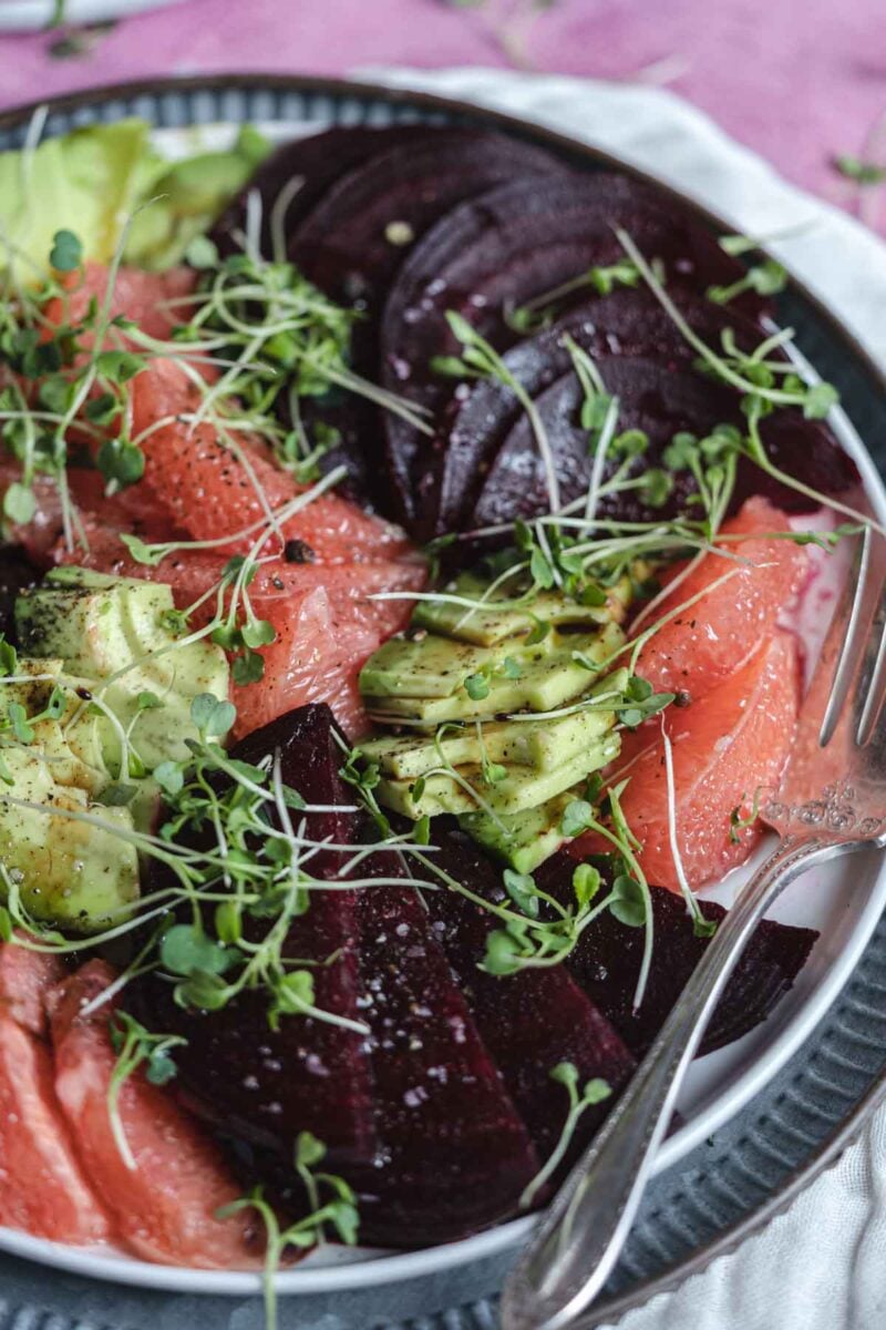 Beet salad on a plate with a fork.