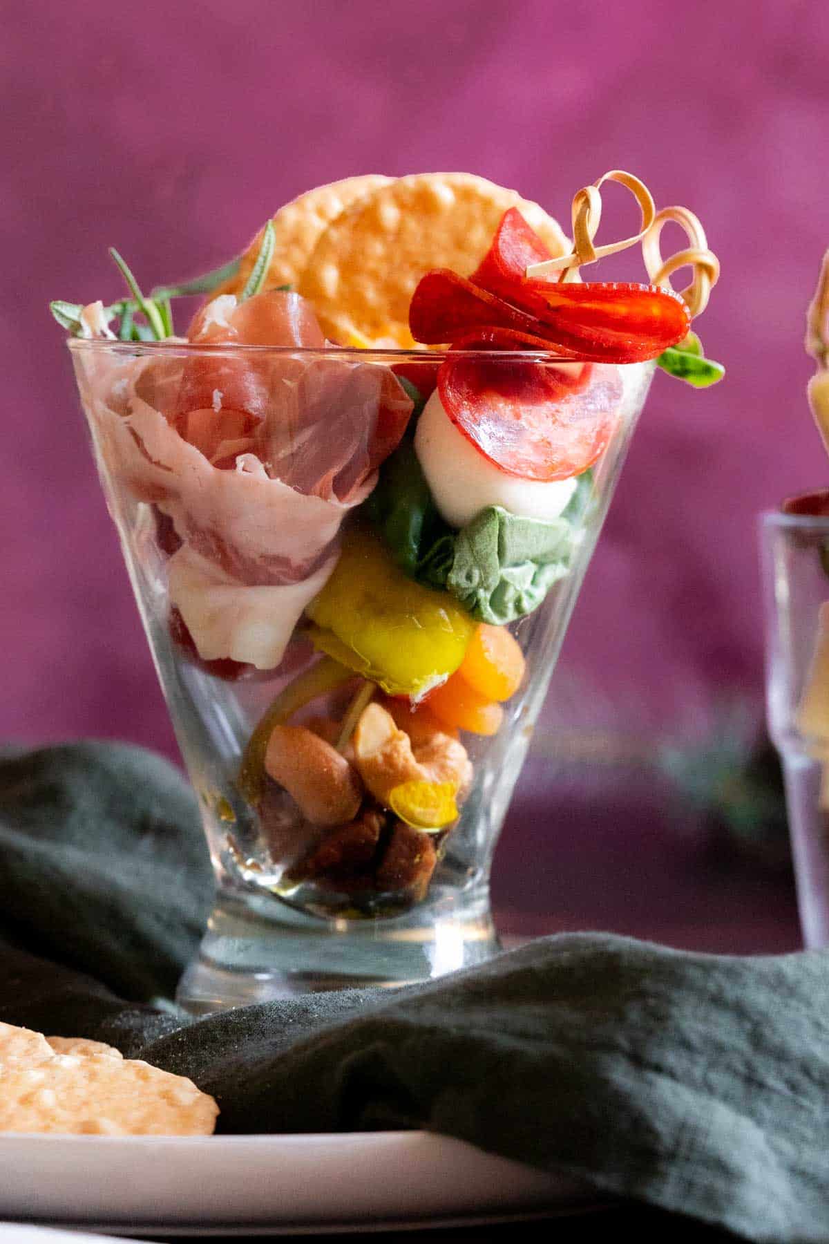 Charcuterie and cheese skewers in a cup.