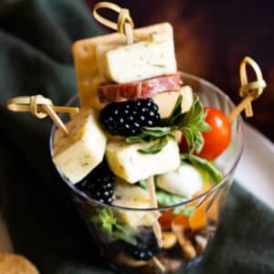 Charcuterie and cheese skewers in a cup.