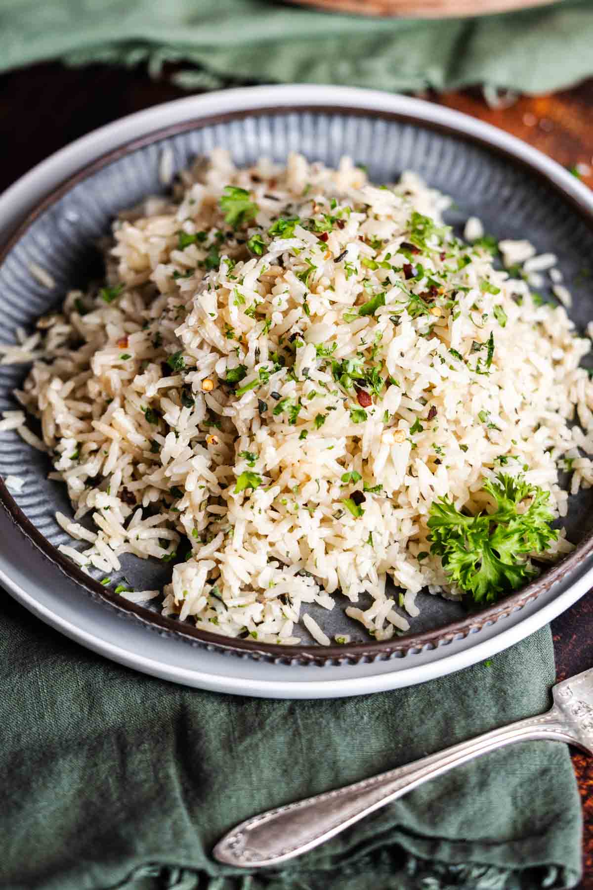 Rice on a plate with green herbs.
