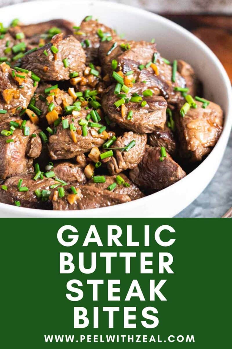 Steak bites with garlic and chives in a serving bowl.