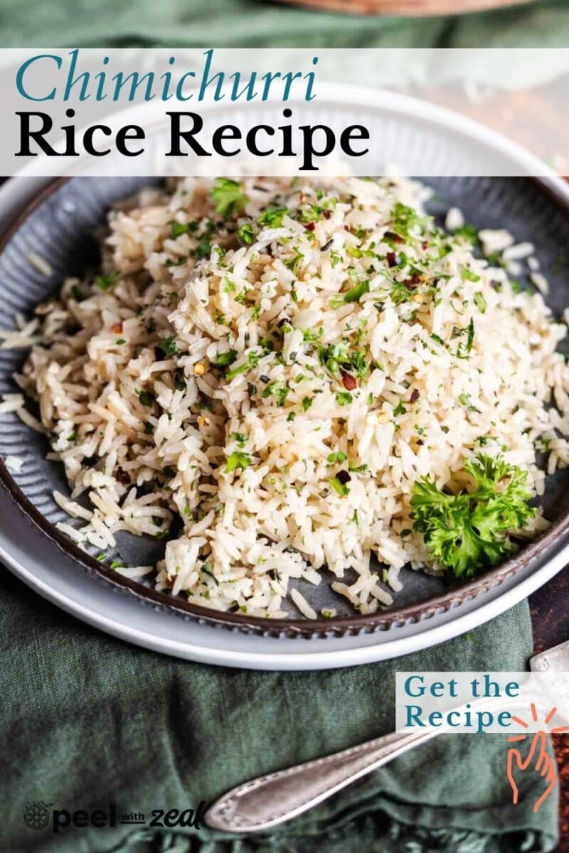 A vibrant plate of chimichurri rice, brightened by fresh herbs, rests elegantly on a textured green surface.