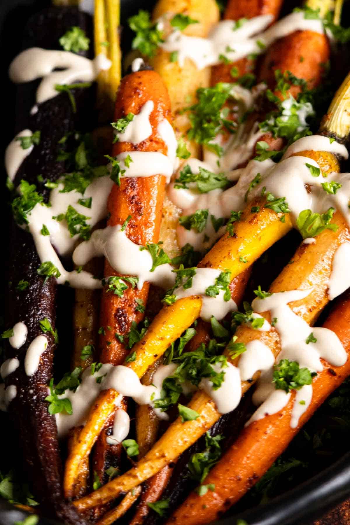Roasted rainbow carrots with tahini and greens.