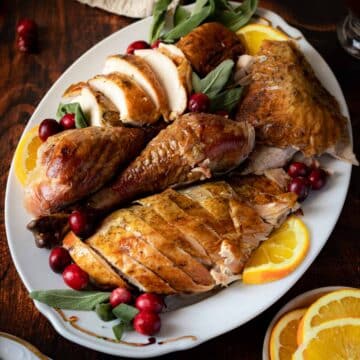 Roasted turkey with sage and sliced oranges.