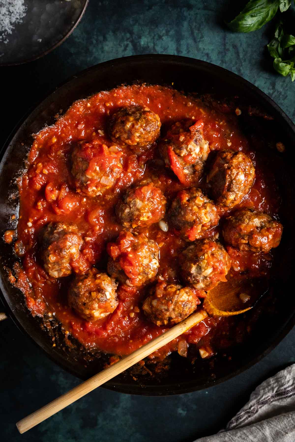 Meatballs in spaghetti sauce in a pan.