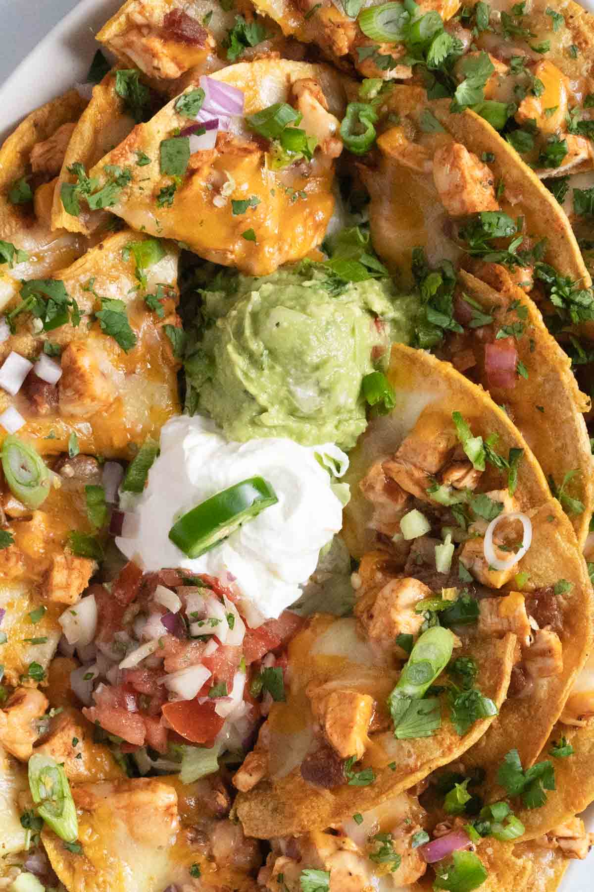 Toppings for nachos including salsa, guacamole, and sour cream.