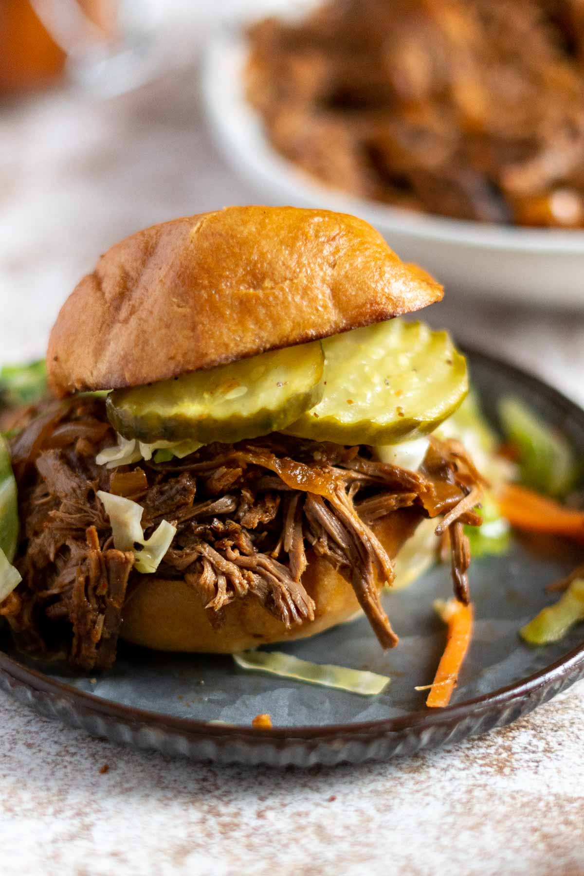BBQ beef sandwich on a plate.