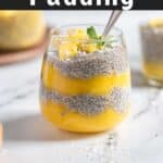 Mango chia pudding in a glass with a spoon.