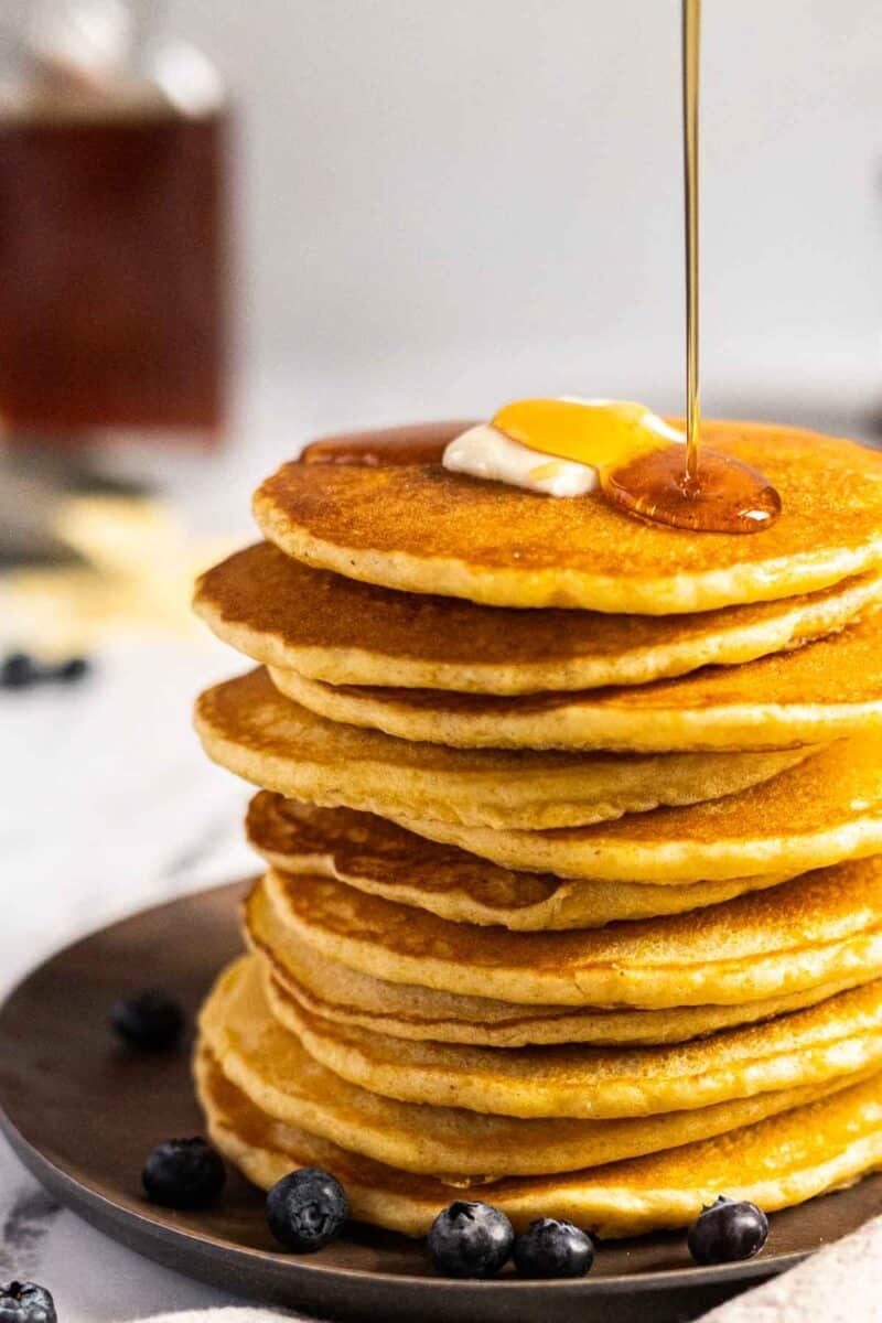 A stack of cornmeal pancakes on a plate.