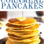 Syrup on stack of cornmeal pancakes.