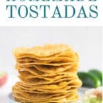 Tostada shells stacked on a plate.